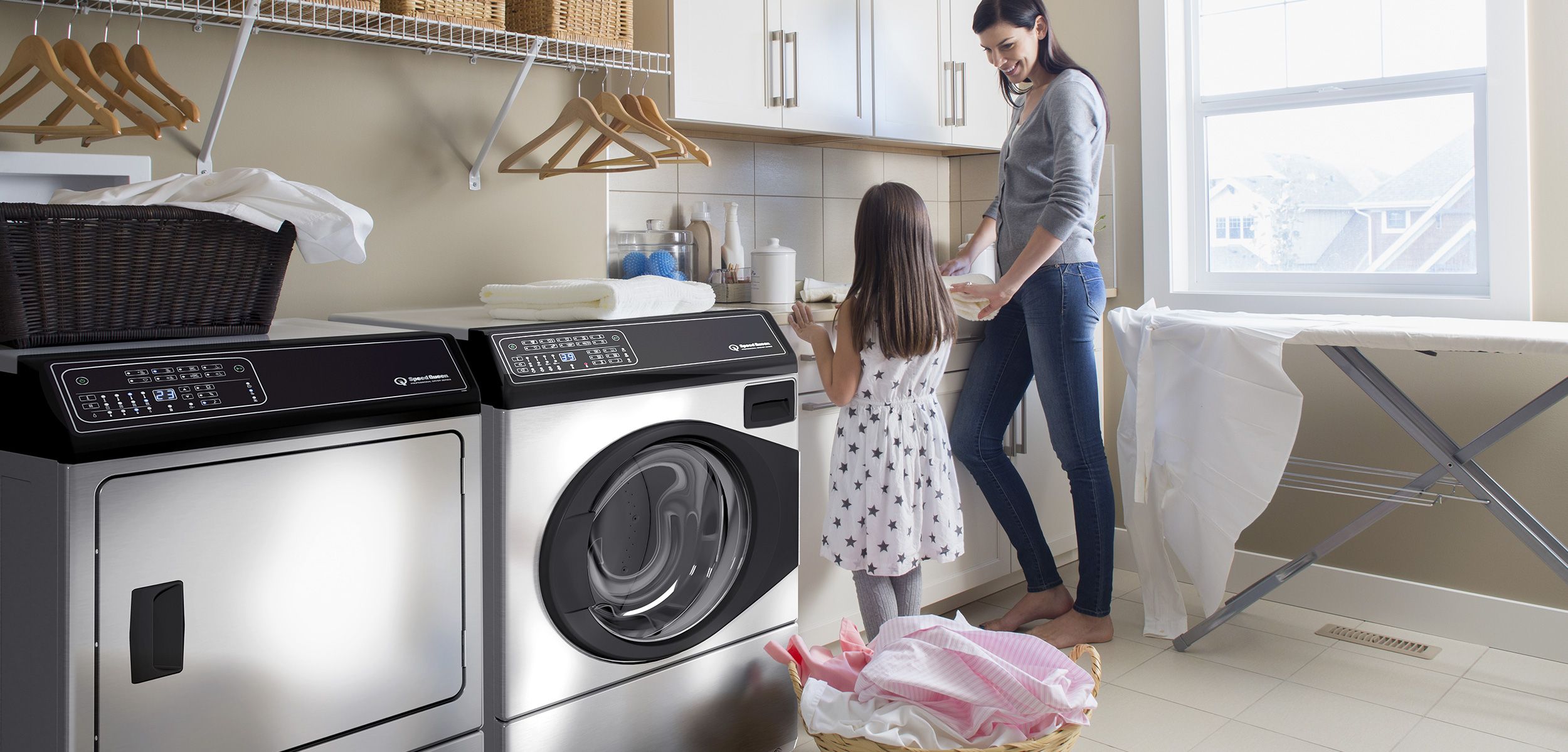 image of a mother and daughter in a laundry room with Speed Queen washer and dryer