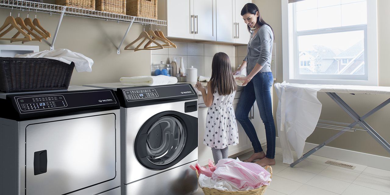 Image of a mother and daughter in the laundry room with Speed Queen machines