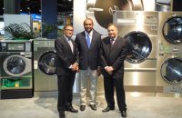 image of Gulf States representatives stanging in front of Huebsch machines