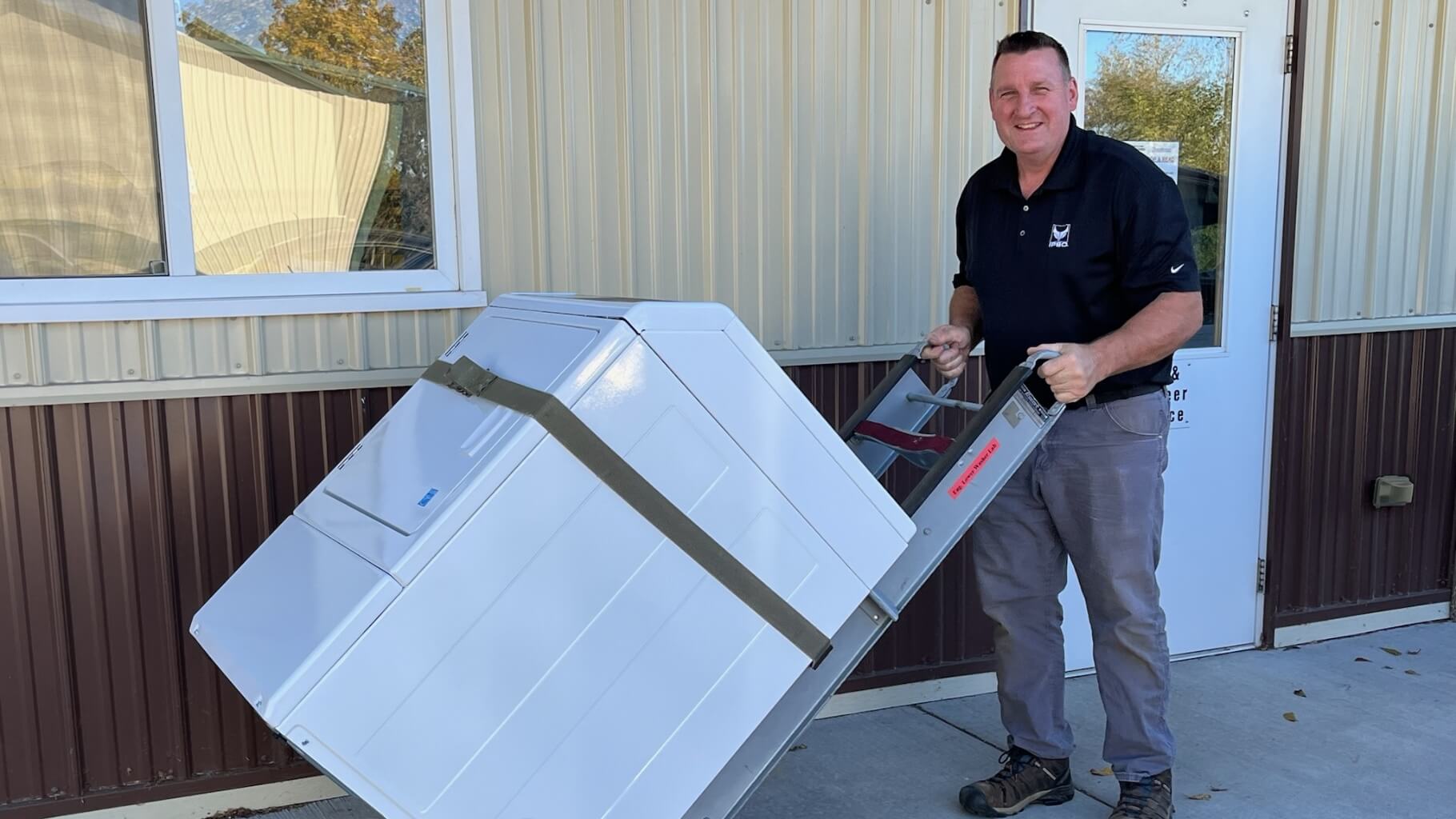 IPSO employee unloading donated laundry equipment