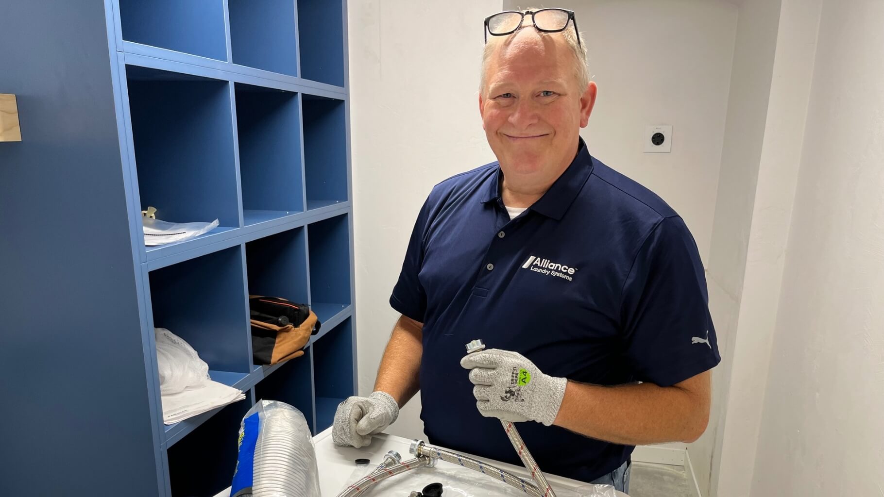 Alliance employee with washing machine hose
