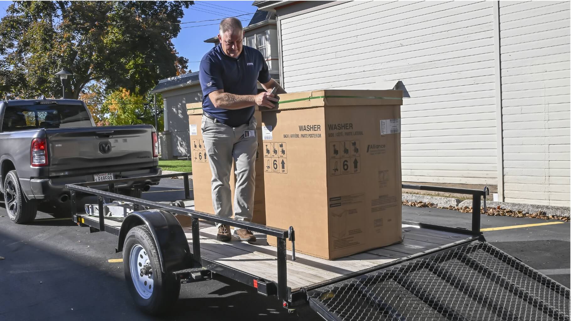 Alliance employee unloading donated washer at preschool