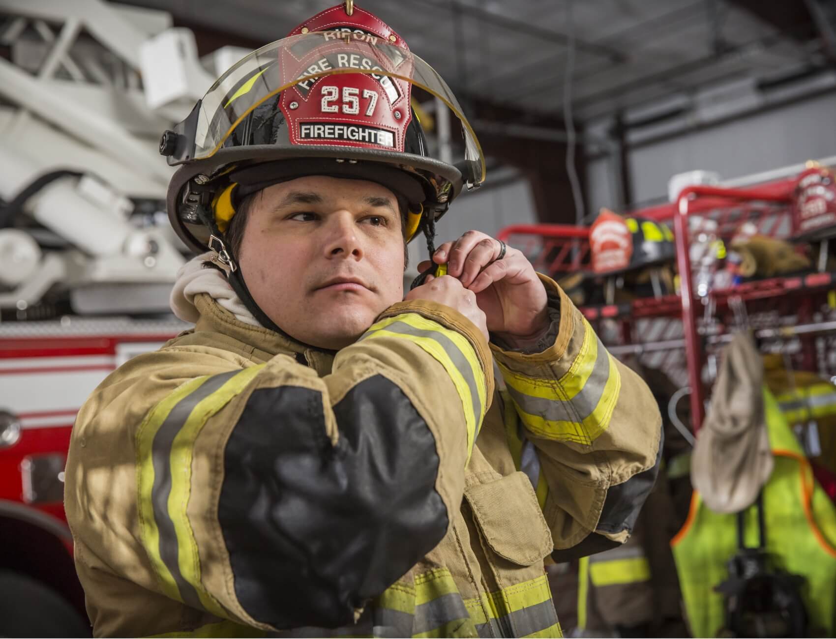 Firefighter adjusting PPE