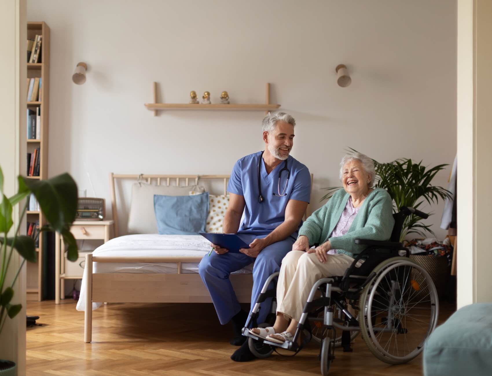 Woman in wheelchair and caregiver in healthcare facility