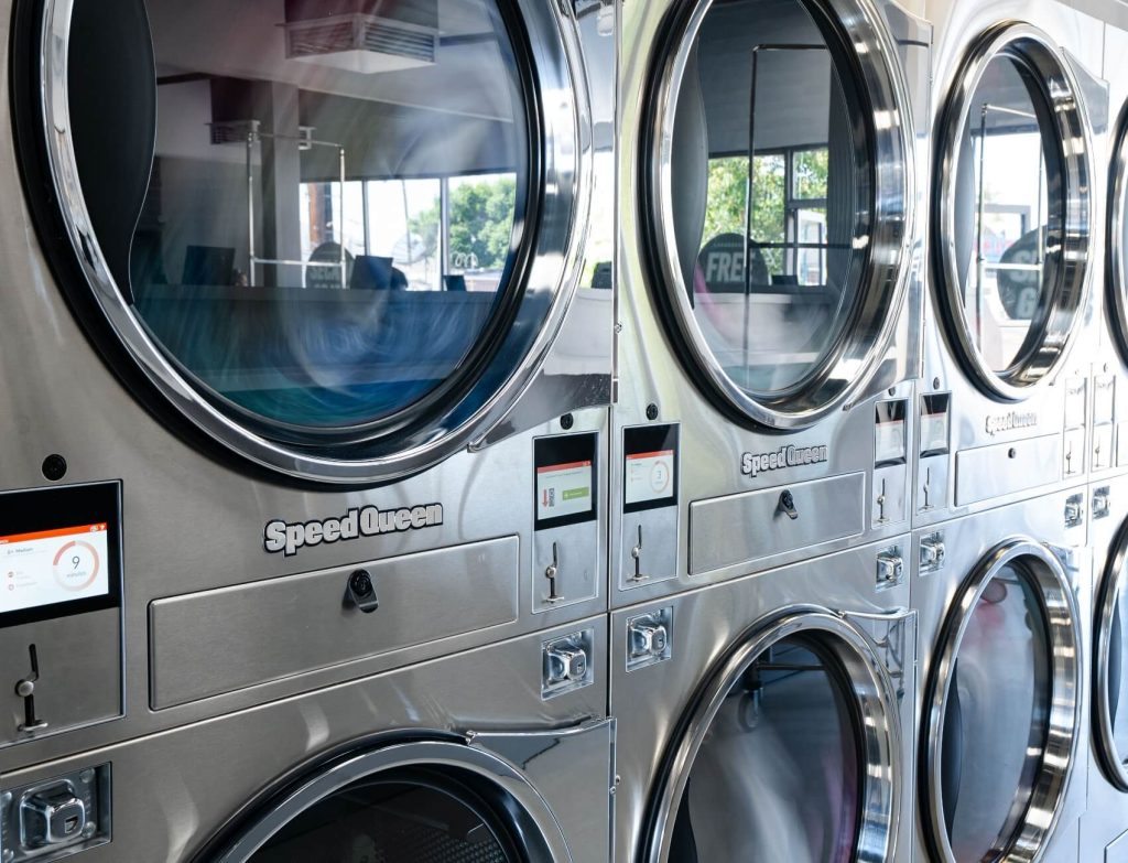 Wall of Speed Queen commercial laundry equipment