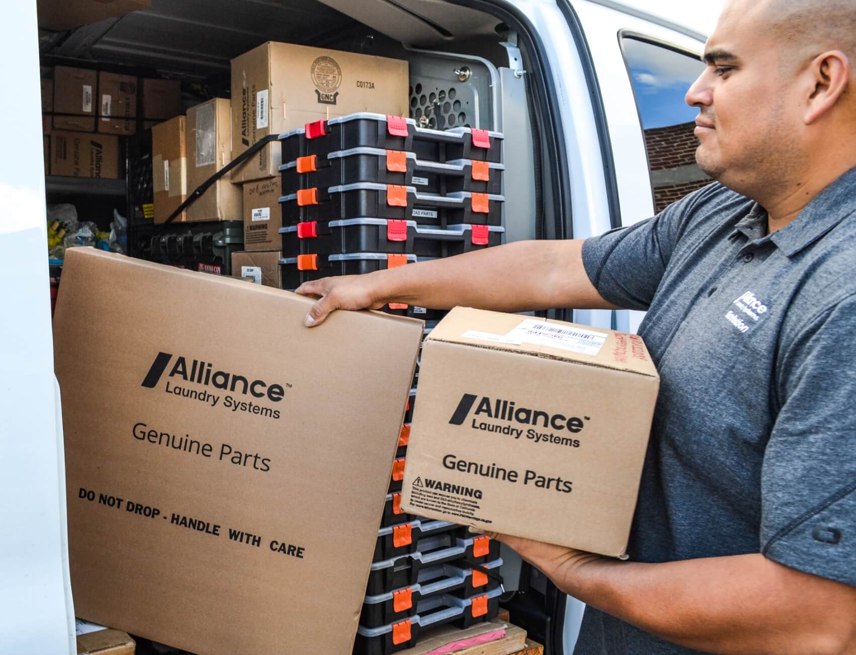 Alliance Genuine Parts employee loading van with boxes