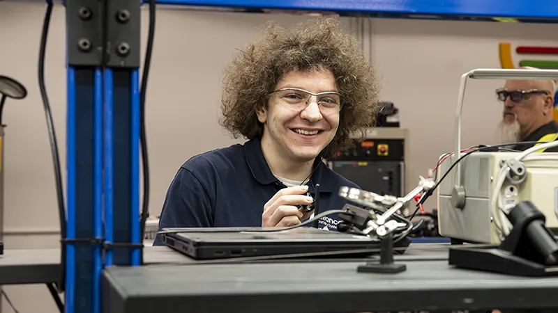 Young Alliance employee working on wiring