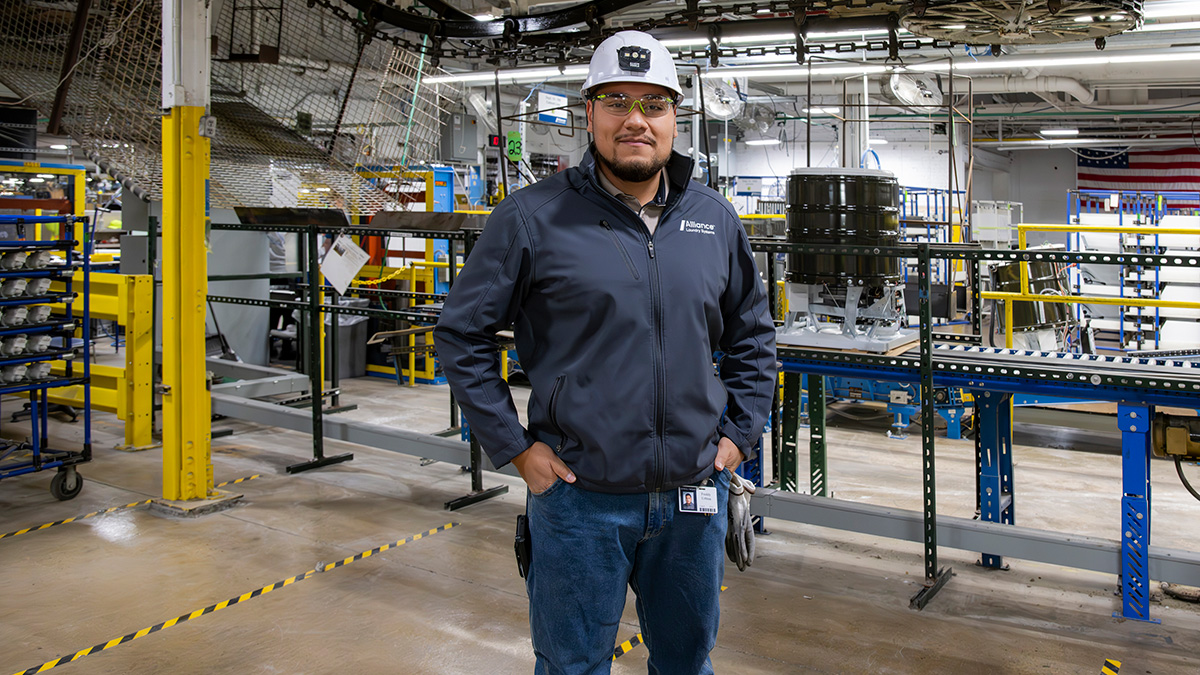 Alliance employee in hard hat in manufacturing facility