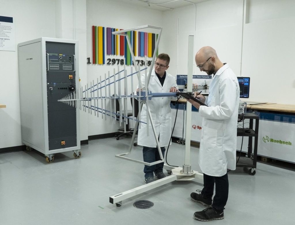 Two Alliance engineers in lab coats working together