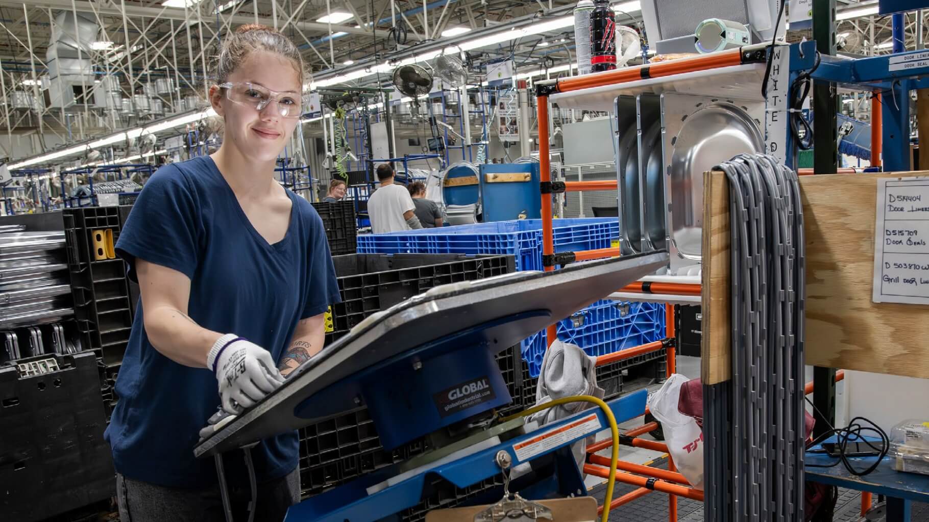 Young employee working in facility with safety gear