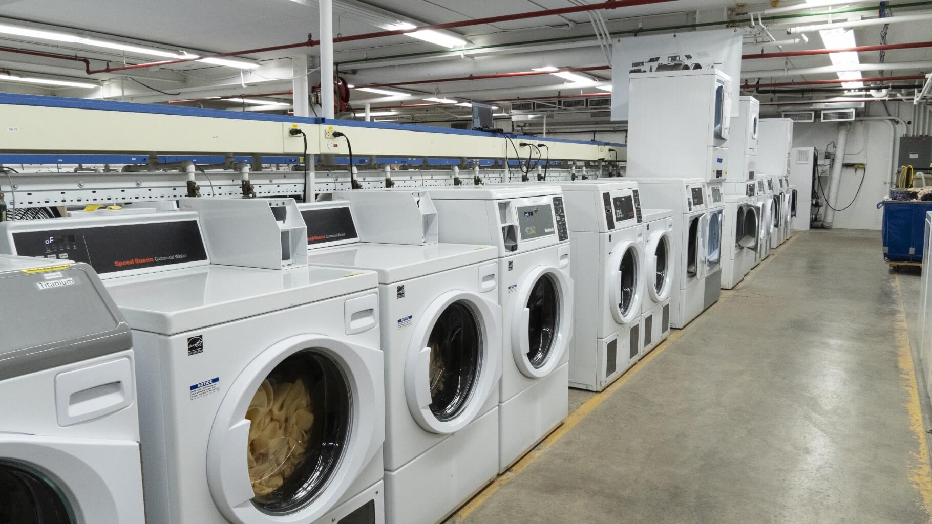 Row of Speed Queen washers inside facility