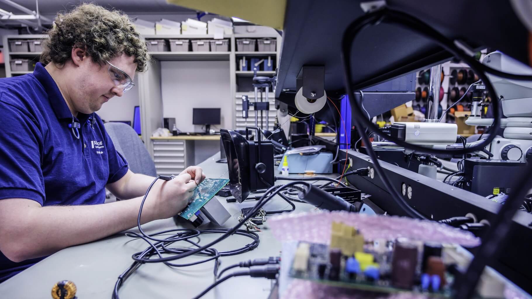 Engineering employee working on circuit board