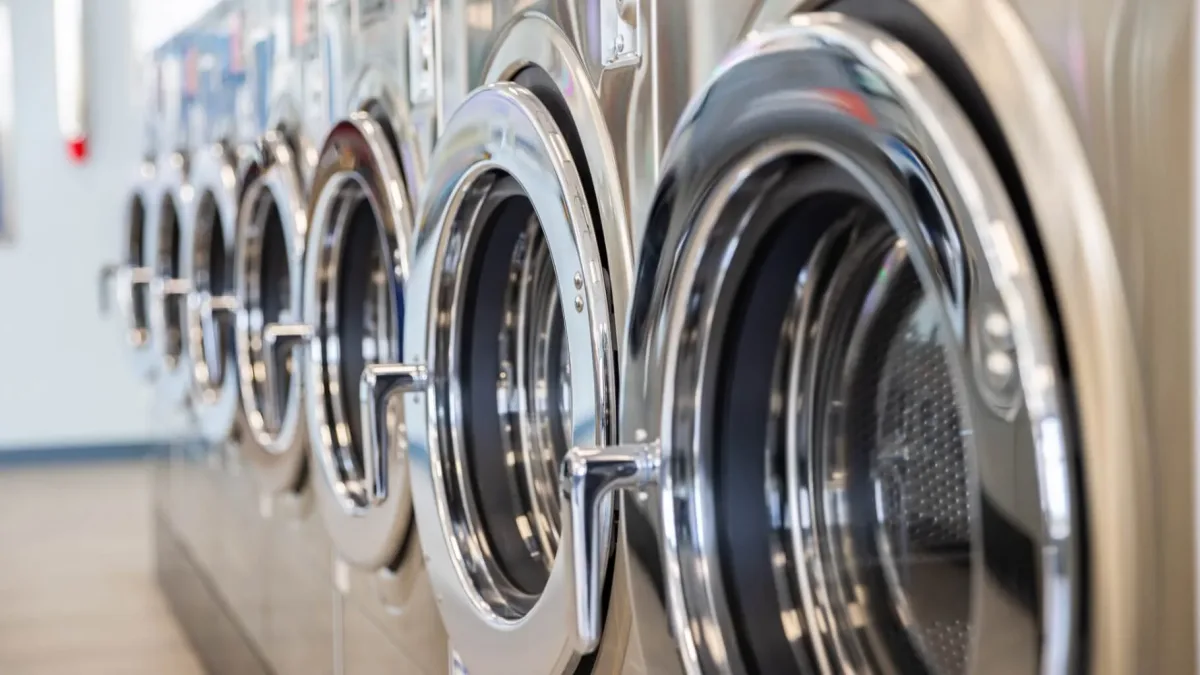 up close view of row of commercial washing machines